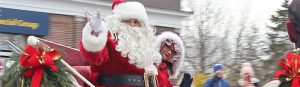 Santa and Mrs Claus arriving by horse-drawn carriage.