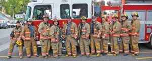 A group of local firefighters posed in front of a fire truck at the Port Dover fire station.